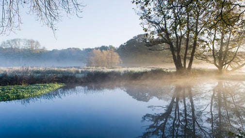 Blue river with frosty fields
